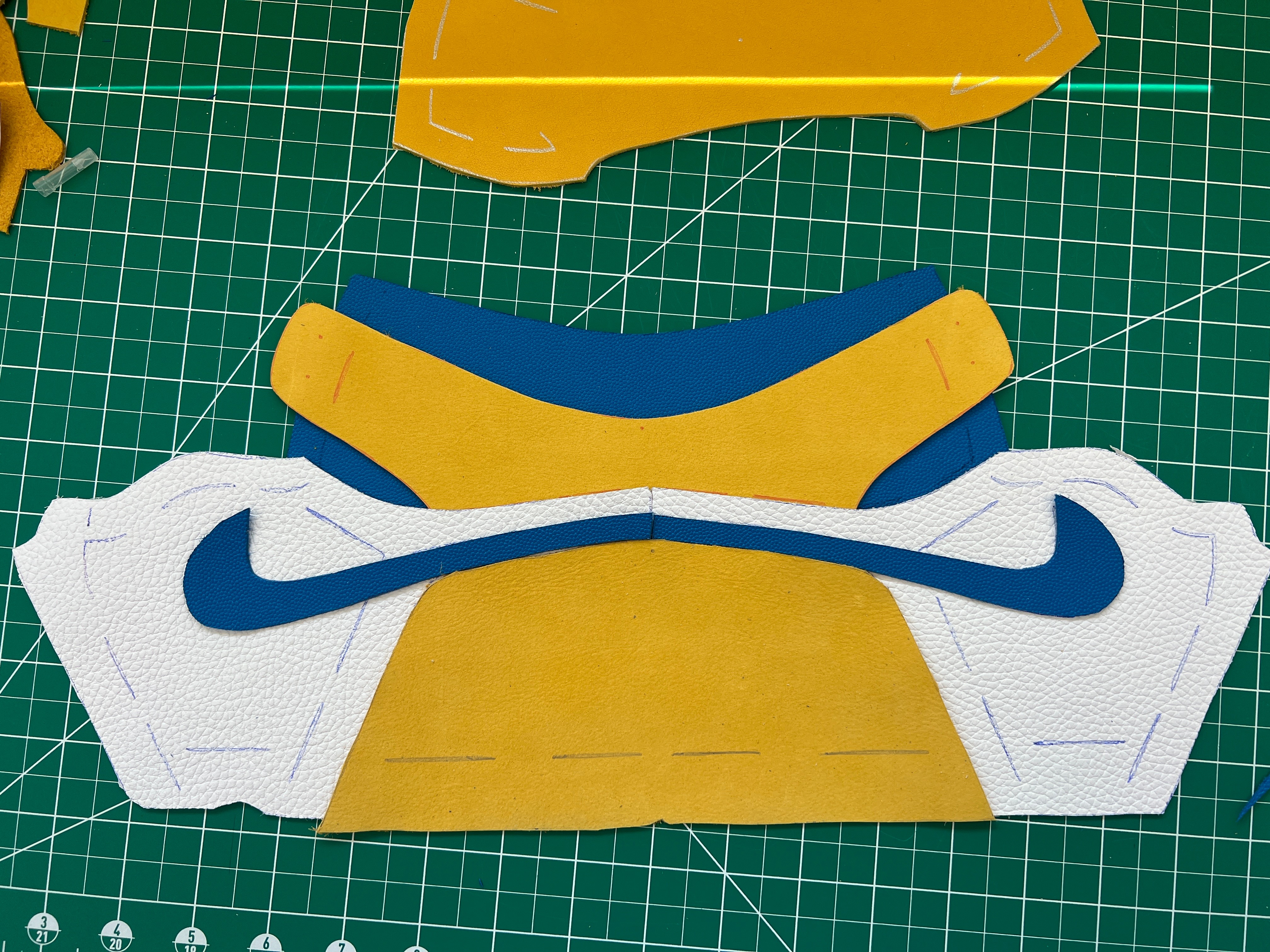 Cut Leather Pieces for Shoe Upper on Cutting Mat